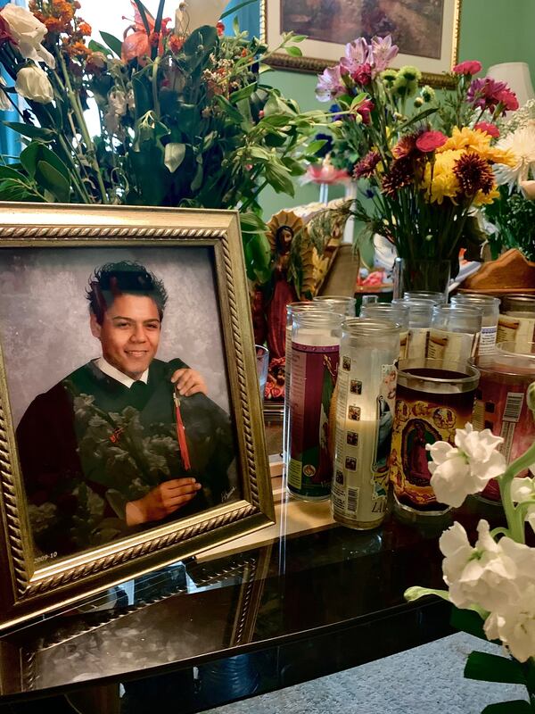 A photograph of Juan Lopez from his high school graduation was placed on top of his casket Thursday after Yessica Lopez closed it.