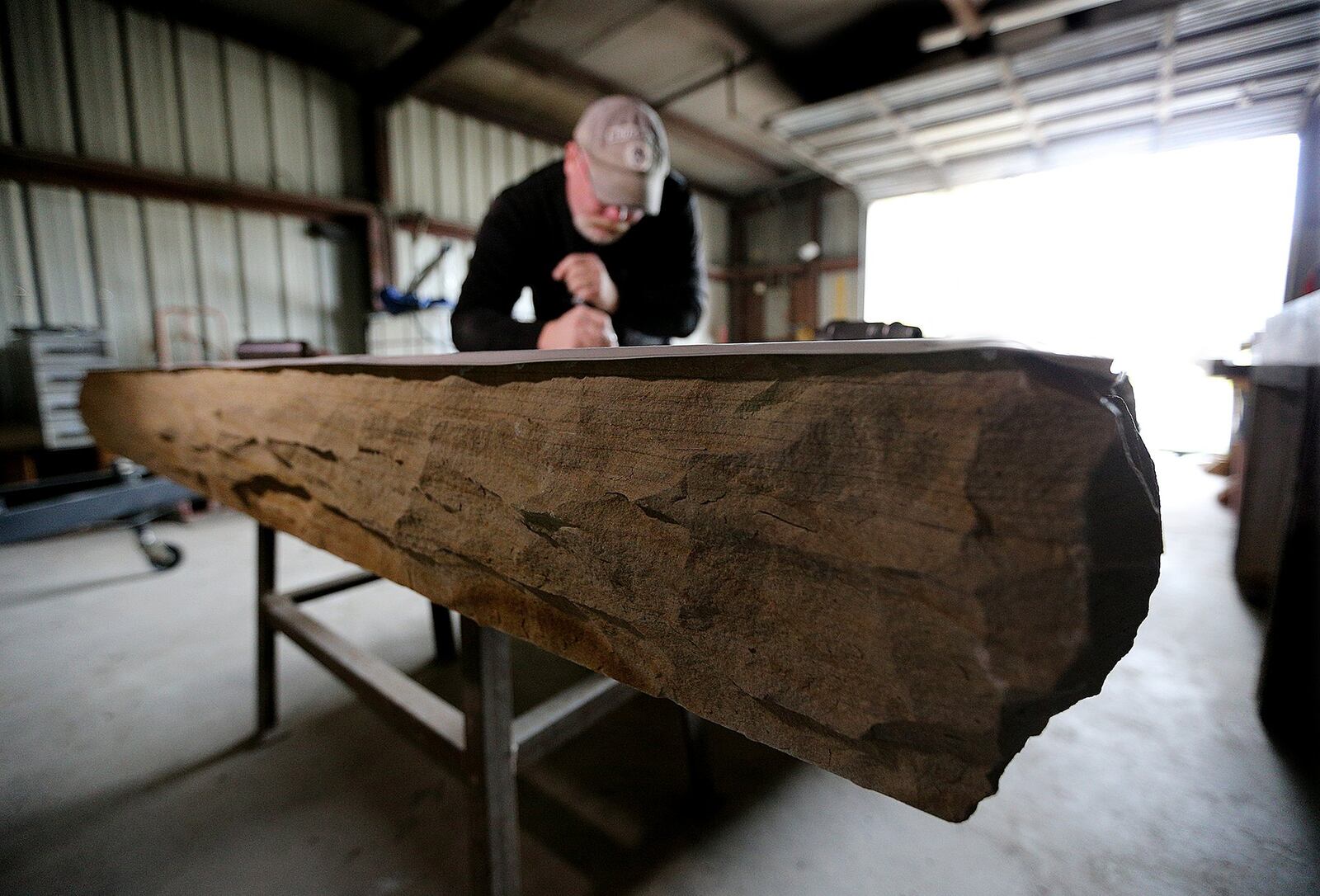 Mart’s design for the monument incorporates Lauren’s artwork, as well as a cross cast in bronze. He started working on the carving in March and expects to finish in September. Photos by Curtis Compton/ccompton@ajc.com