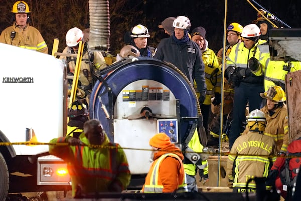 Rescue workers search in a sinkhole for Elizabeth Pollard, who disappeared while looking for her cat, in Marguerite, Pa., Tuesday, Dec. 3, 2024. (AP Photo/Gene J. Puskar)