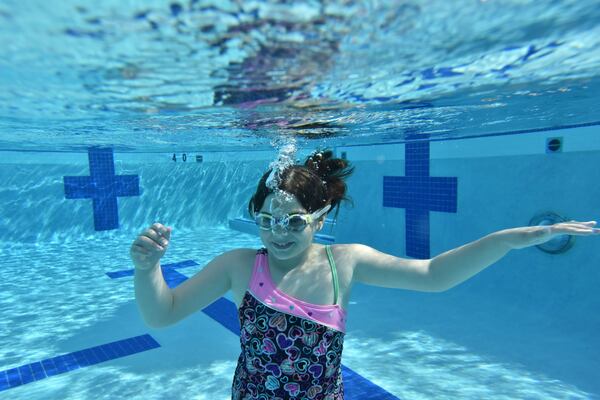 In this file photo, Sarah Frierson swims to the bottom of the pool at the Emory Aquatics Center at the Student Activity and Academic Center. HYOSUB SHIN / HSHIN@AJC.COM