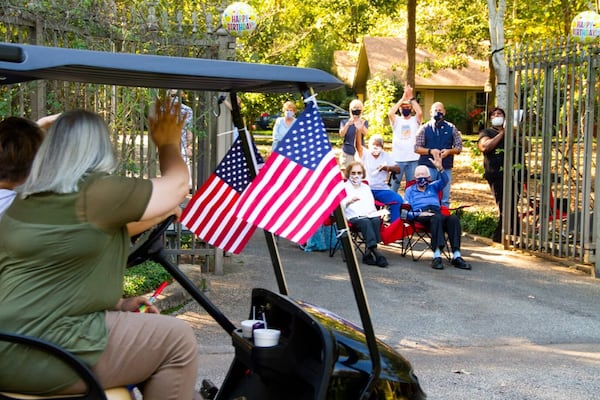 Former President Jimmy Carter and his wife, Rosalynn, wave at folks wishing him a happy 96th birthday on Thursday, Oct. 1, 2020.