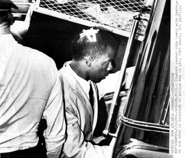 John Lewis as a wounded student leader and civil rights activist in 1961 in Jackson, Mississippi, entering a police van. (credit: UPI pb/Files)