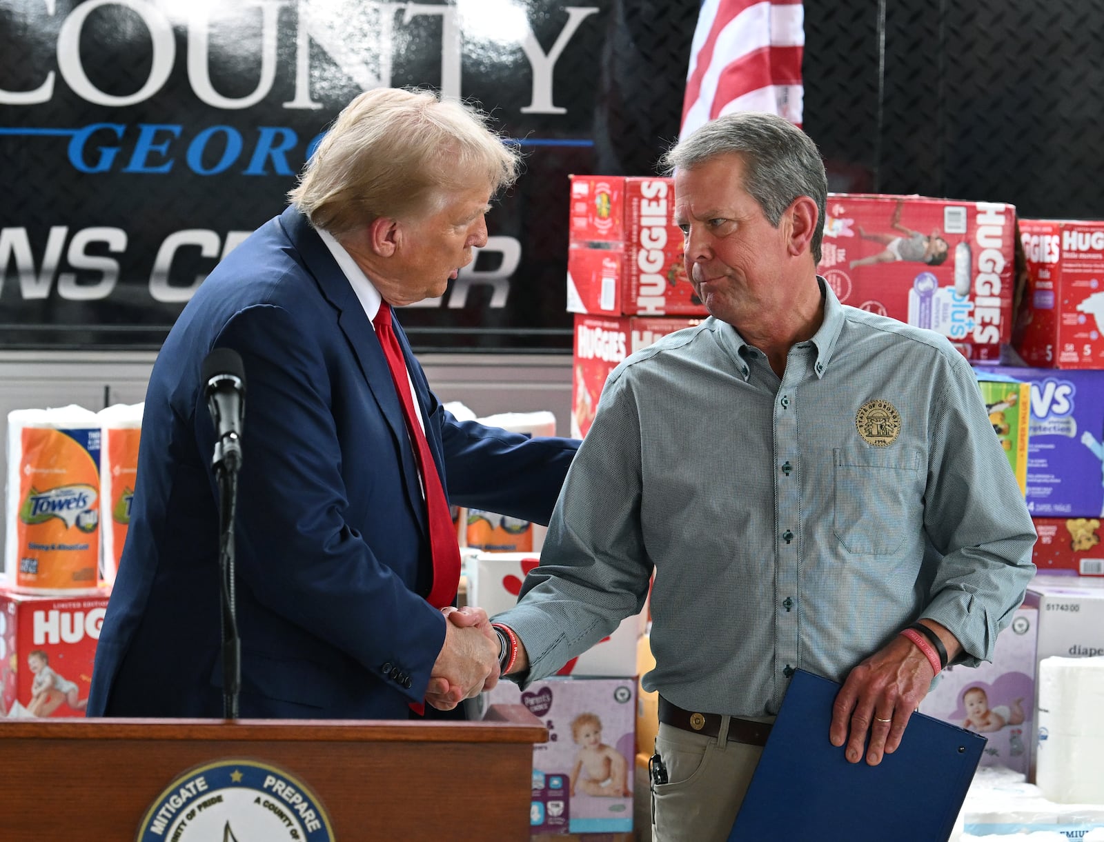 Former President Donald Trump greets with Gov. Brian Kemp during a press event while traveling to east Georgia to survey damage from Hurricane Helene, Friday, October 4, 2024, in Evans. Former President Donald Trump and Gov. Brian Kemp made their first appearance together since before the 2020 election, traveling to east Georgia to survey damage from Hurricane Helene. (Hyosub Shin / AJC)