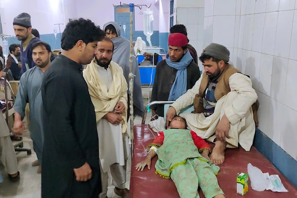 Family members stand around a girl injured in the bomb explosion as she receives treatment at a hospital in Bannu, northwest Pakistan, Tuesday, March 4, 2025. (AP Photo/Ijaz Muhammad)