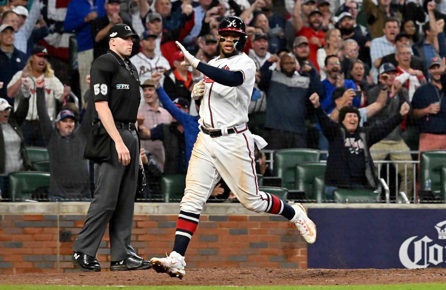 Atlanta Braves right fielder Ronald Acuna (13) scores against the Philadelphia Phillies on an RBI single by Atlanta Braves first baseman Matt Olson during the sixth inning of game two of the National League Division Series at Truist Park in Atlanta on Wednesday, October 12, 2022. (Hyosub Shin / Hyosub.Shin@ajc.com)