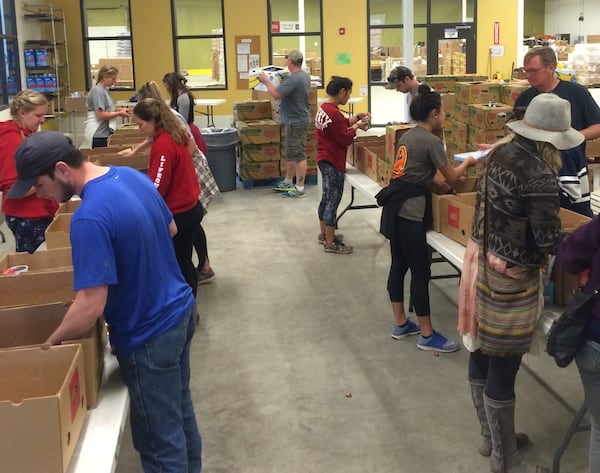 Community volunteers sort donated food to be sure everything is safe to eat and in good shape. Photo credit: Food Bank of Northeast Georgia