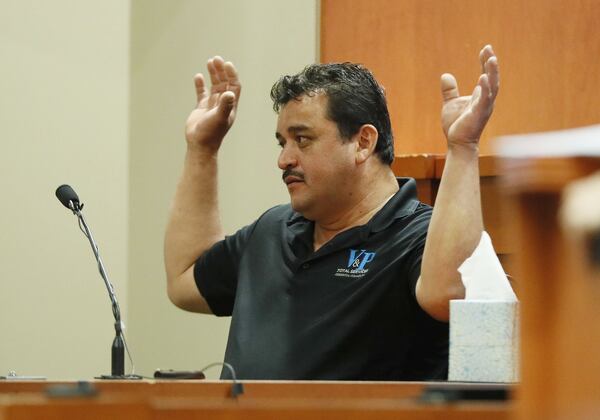 Pedro Castillo Flores shows how Anthony Hill had his hands raised before the shooting. Flores testified on Sept. 26 and Sept. 27, 2019, at DeKalb County Superior Court in the murder trial of former DeKalb police officer Robert “Chip” Olsen. Anthony Hill, an Afghanistan War veteran, was mentally ill, naked and unarmed when Olsen shot him. (photo: Bob Andres / robert.andres@ajc.com)