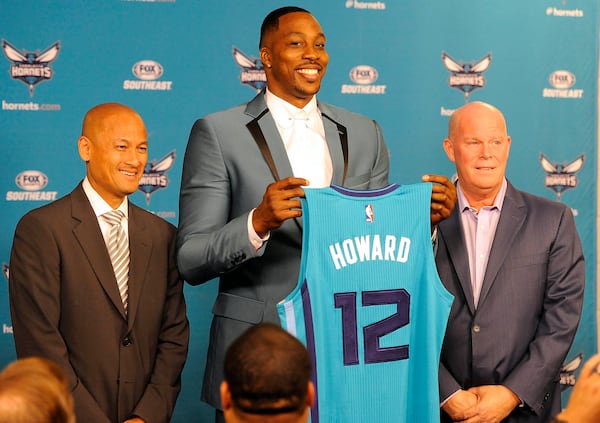 The Charlotte Hornets new center Dwight Howard poses with his jersey alongside General Manager Rich Cho (left) and head coach Steve Clifford during a news conference Monday.