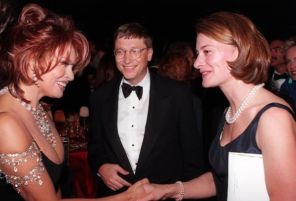 FILE — Raquel Welch, left, greets Bill and Melinda Gates at a gala in New York on March 3, 1998. Welch, the voluptuous movie actress who became the 1960s’ first major American sex symbol and maintained that image in a show business career that lasted a half-century, died on Wednesday, Feb. 15, 2023, at her home in Los Angeles. She was 82. (Bill Cunningham/The New York Times)