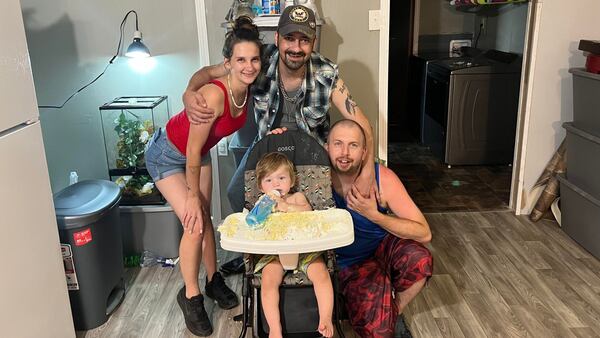 Anthony Maurice Tollison's niece Julianna Lynn (left), his husband Travis Tollison (right) and great nephew Andy gathered in July for a cake smash.