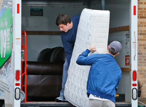 Two men load a mattress from the now closed University of Oklahoma's Sigma Alpha Epsilon fraternity house into a moving truck, in Norman, Okla., Tuesday, March 10, 2015. University President David Boren expelled two students Tuesday after he said they were identified as leaders of a racist chant captured on video during a fraternity event. (AP Photo/Sue Ogrocki) Two men load a mattress from the now closed University of Oklahoma's Sigma Alpha Epsilon fraternity house into a moving truck, in Norman, Okla., Tuesday. President David Boren expelled two students Tuesday after he said they were identified as leaders of a racist chant captured on video during a fraternity event. (AP Photo/Sue Ogrocki)