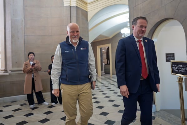 Rep. Chip Roy, R-Texas, left, and Rep. Michael Cloud, R-Texas, arrive for a meeting with Speaker of the House Mike Johnson, R-La., at the Capitol in Washington, Friday, Dec. 20, 2024. (AP Photo/J. Scott Applewhite)