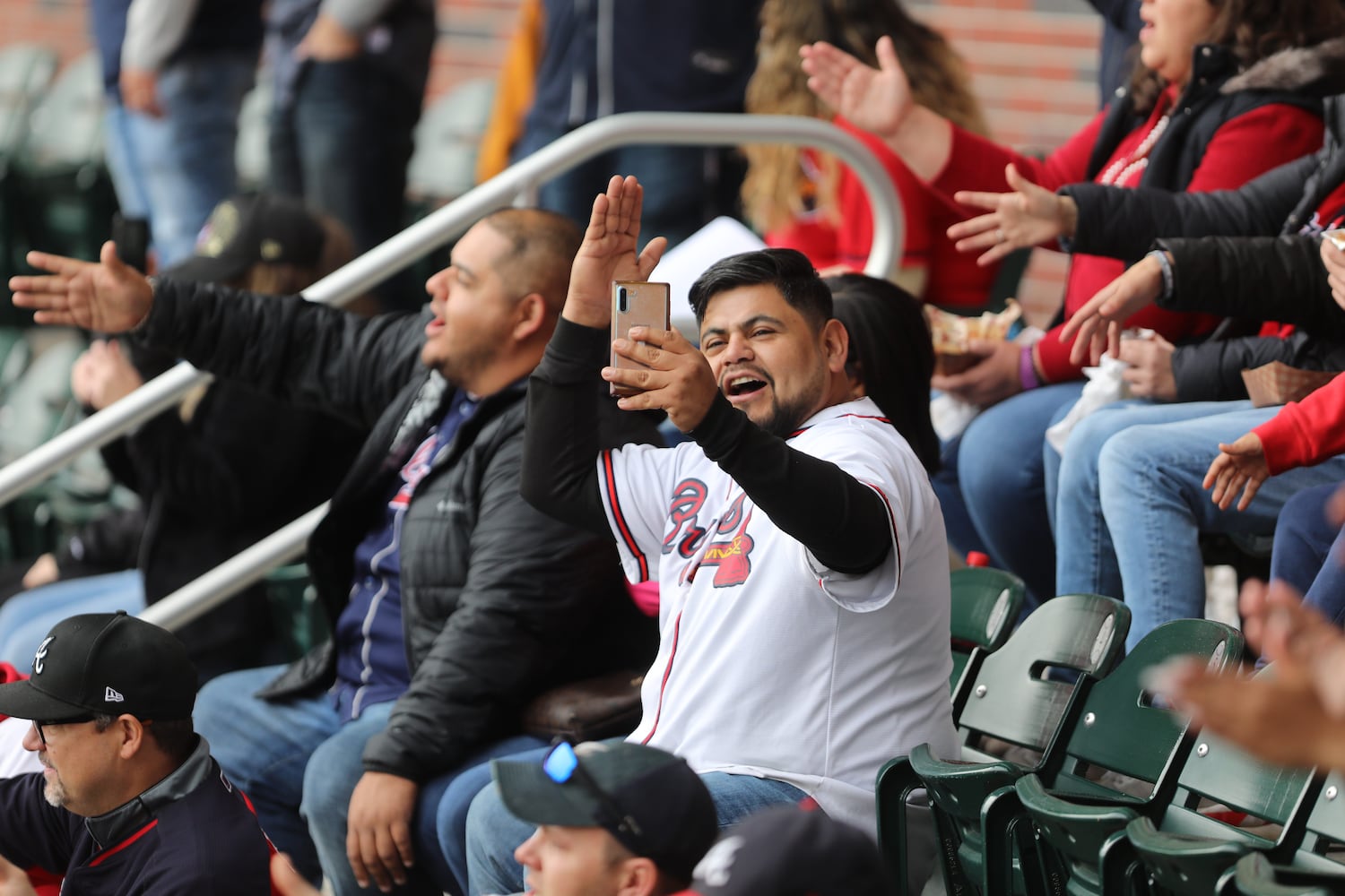 Atlanta Braves fan film himself doing the tomahawk chop at Truist Stadium on Friday, November 5, 2021. Miguel Martinez for The Atlanta Journal-Constitution