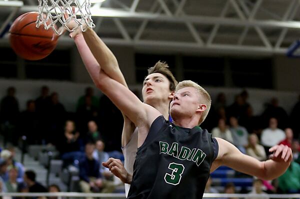 Badin forward Seth Thompson has his shot knocked away by St. Xavier forward Brandon Gilbert during Tuesday night’s game at Berning Gymnasium in Springfield Twp. CONTRIBUTED PHOTO BY E.L. HUBBARD