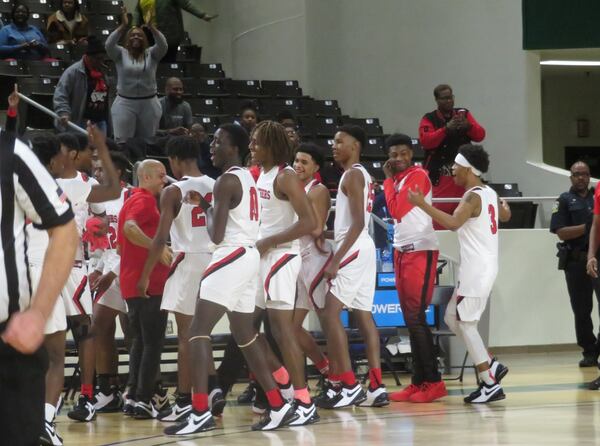 The Therrell Panthers celebrate following their win over the Chattooga Indians in the Class AA semifinal on Saturday, Feb. 29, 2020 at Georgia College and State University's Centennial Center in Milledgeville. (Adam Krohn for the AJC)