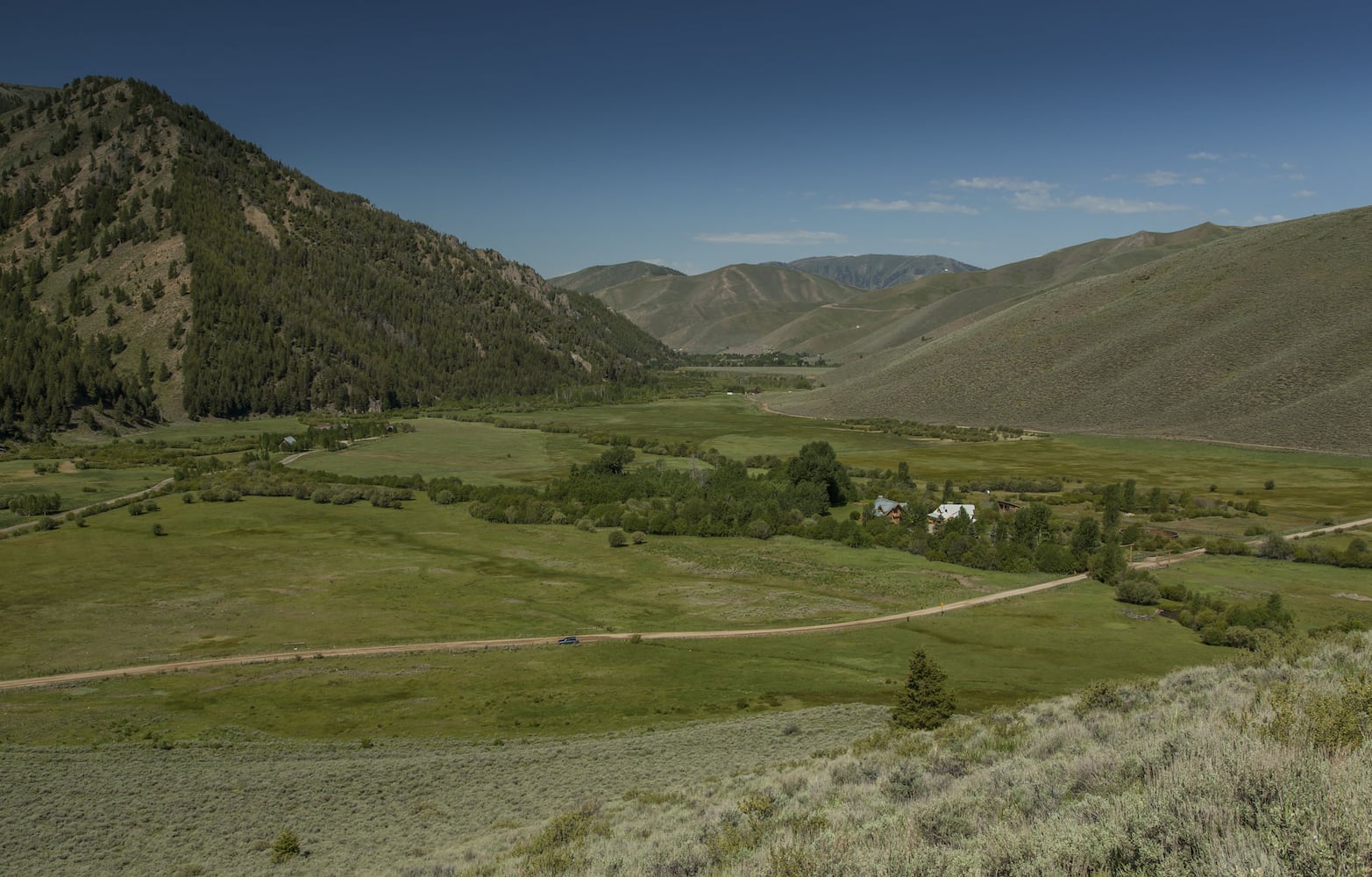 500-acre property has log cabins, mountain views