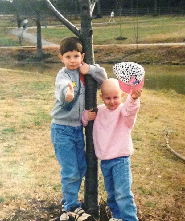 When Bridget Sandy's blond, curly hair fell out from chemo treatments, she scoffed at the wigs her parents bought her. “I would always wear a baseball cap, so that was my thing,” said Sandy, shown here with her brother, Tony.
Photo courtesy of Bridget Sandy