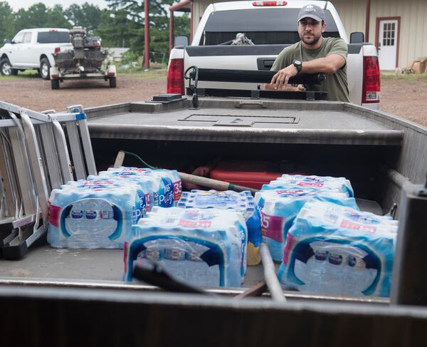 Casey Korkmas of Tyler, Texas, helps pack supplies into a boat at WC Custom Boats in Noonday, Texas where several volunteers met to head to areas affected by Hurricane Harvey Monday morning Aug. 28, 2017. The group took six boats stocked with fuel and water headed to the Houston area to assist in Hurricane Harvey rescue efforts. (Sarah A. Miller/Tyler Morning Telegraph via AP)