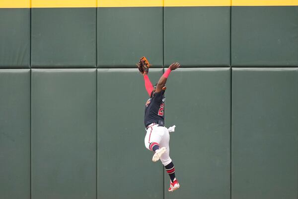 Atlanta Braves center fielder Michael Harris II makes a leaping catch at the wall on a flyout by Philadelphia Phillies Brandon Marsh to end the third inning of a spring training baseball game in North Port, Fla., Saturday, March 18, 2023. (AP Photo/Gerald Herbert)