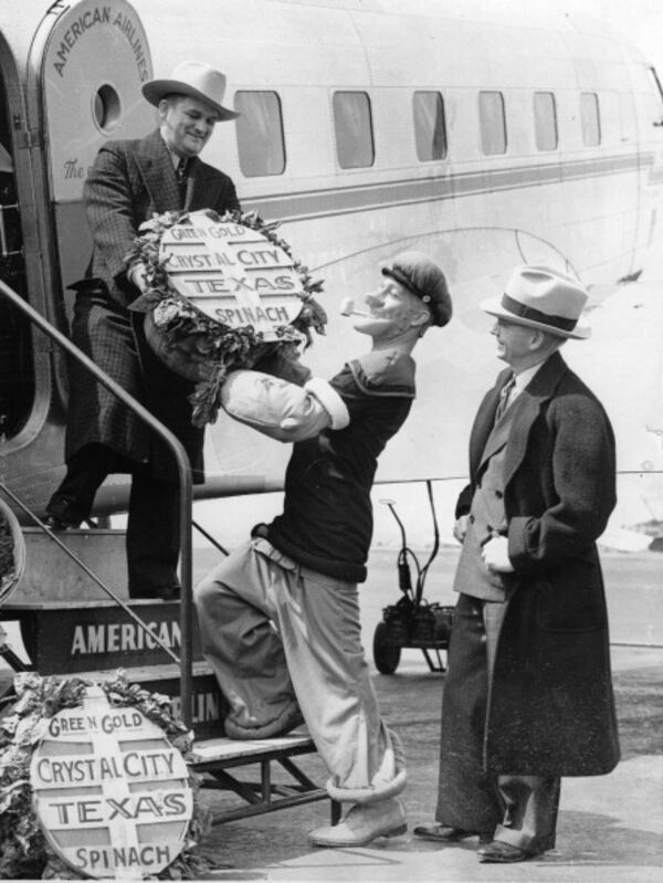 In happier times, Crystal City, Texas was known for spinach instead of public corruption. Here, in 1936, E.C. Segar, comic artist, and Popeye the Sailor, greets Mayor B.H. Holsomback, Crystal City, Texas, at his arriving in Newark. (Photo by Imagno/Getty Images)