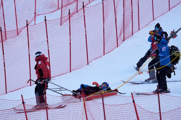 Mikaela Shiffrin, of the United States, is taken down the mountain on a sled by ski patrol after crashing during the second run of a women's World Cup giant slalom skiing race, Saturday, Nov. 30, 2024, in Killington, Vt. (AP Photo/Robert F. Bukaty)