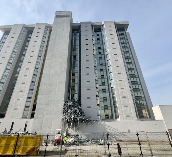 Demolition crews yank metal from the old Macon Hilton as they prepare the half-century-old structure for implosion on New Year's Day. (Joe Kovac Jr. / AJC)