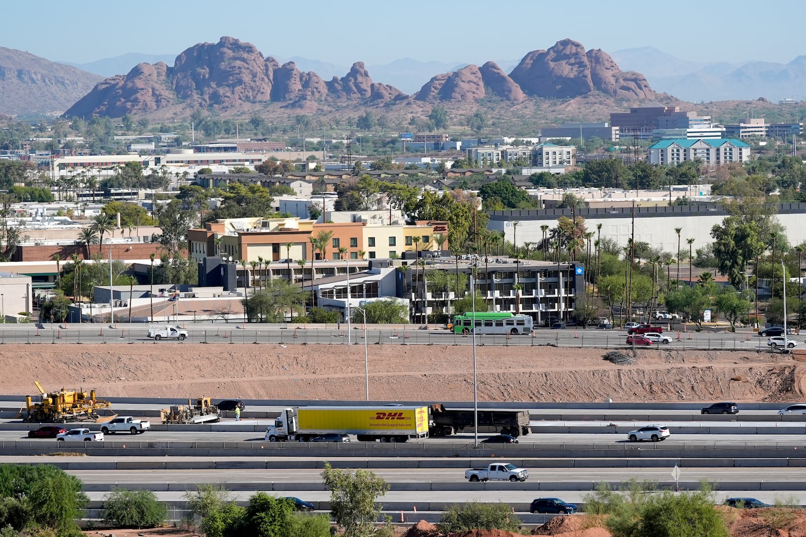 Interstate 10 slices through an area of mixed use businesses and hotels Tuesday, Sept. 24, 2024, in Tempe, Ariz. (AP Photo/Ross D. Franklin)