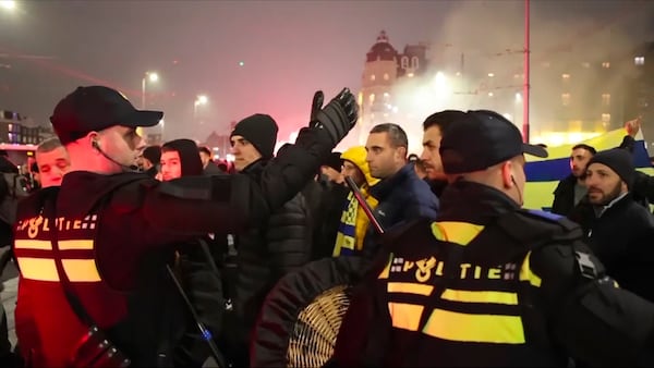 In this image taken from video, police escort Maccabi Tel Aviv supporters to the metro station leading them to the Ajax stadium, after pro-Palestinian supporters marched near the stadium, in Amsterdam, the Netherlands, Thursday, Nov. 7, 2024. (AP Photo InterVision)