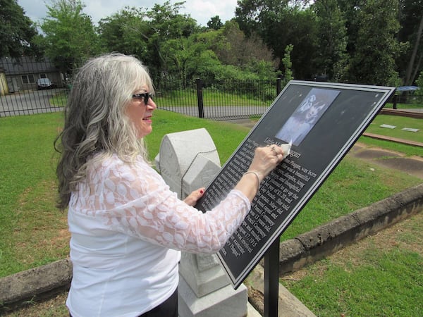 Mary Phagan-Kean cleans a marker at the resting place of her great-aunt and namesake, Mary Phagan. Photo: Jennifer Brett