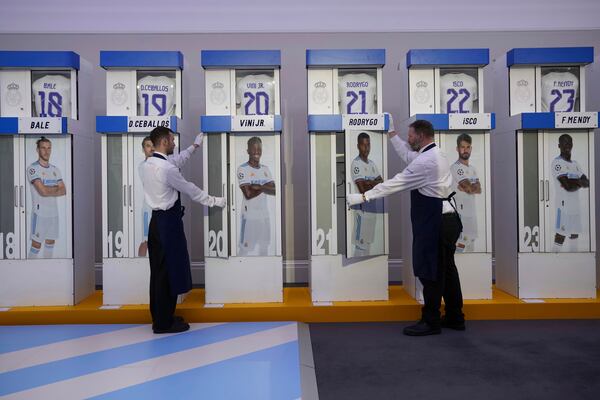 The Real Madrid first-team changing room lockers from Santiago Bernabeu Stadium are displayed at Sotheby's auction rooms in London, Wednesday, Nov. 20, 2024. The sale features 24 individual lockers previously used by footballers including Cristiano Ronaldo, David Beckham and Zinedine Zidane. (AP Photo/Kin Cheung)