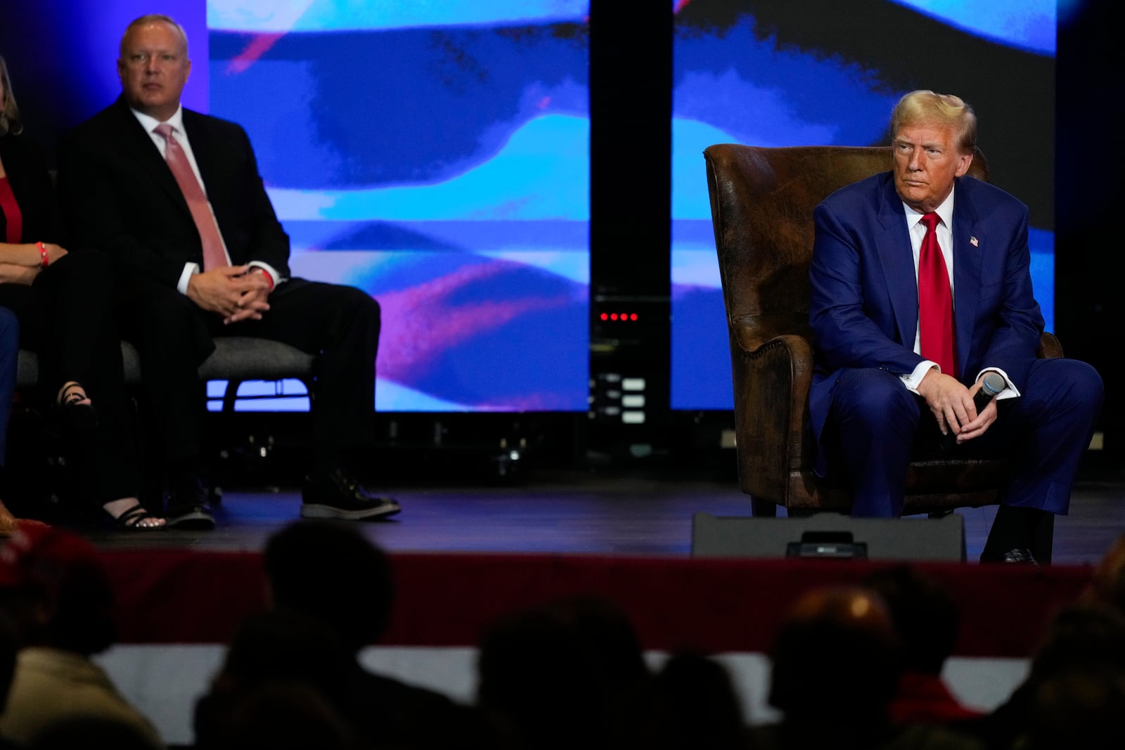 Republican presidential nominee former President Donald Trump listens during a faith town hall with Georgia Lt. Gov. Burt Jones at Christ Chapel Zebulon, Wednesday, Oct. 23, 2024, in Zebulon, Ga. (AP Photo/Julia Demaree Nikhinson)