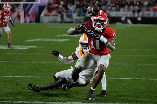 Georgia wide receiver Arian Smith (11) can't hang on to a pass as Tennessee defensive back Rickey Gibson III (1) defends during the second half of an NCAA college football game, Saturday, Nov. 16, 2024, in Athens, Ga. (AP Photo/John Bazemore)