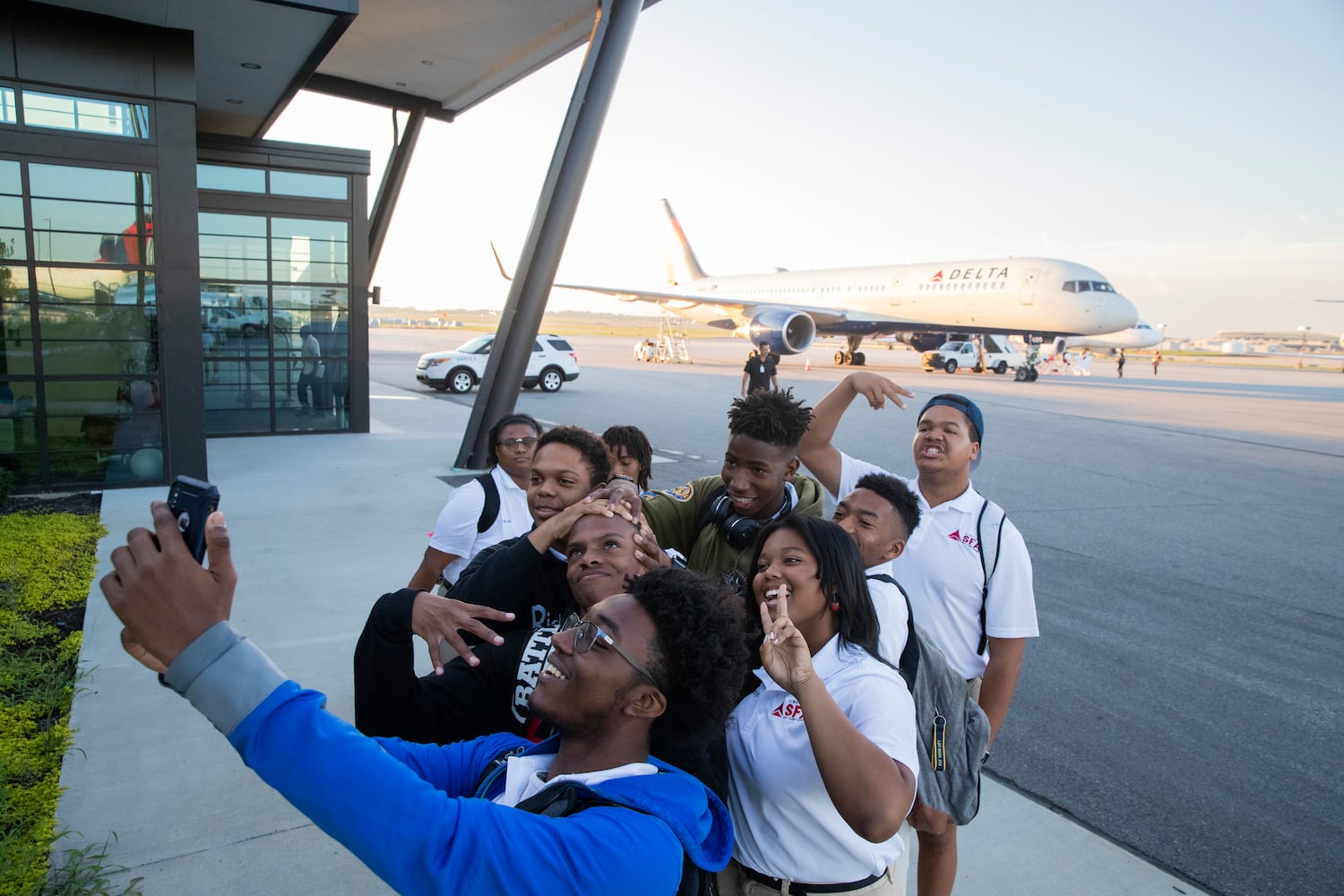 Khye Felder, 17, takes a selfie with other students of the Solo Flight Academy as they walk to board a plane as part of Delta’s Dream Flight 2022 event at Hartsfield-Jackson Atlanta International Airport on Friday, July 15, 2022. Around 150 students ranging from 13 to 18 years old will fly from Atlanta to the Duluth Air National Guard Base in Duluth, Minnesota. (Chris Day/Christopher.Day@ajc.com)