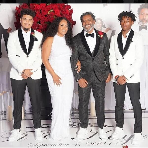 Tiran Jackson, (Black suit), with Kaye Jackson on their wedding day. They are flanked by Cameron (far right) and Jaylen.