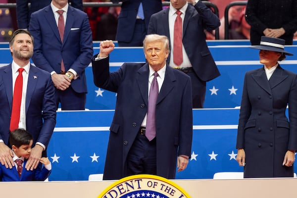 President Donald Trump raises his fist at the inaugural parade at Capital One Arena in Washington on Monday.