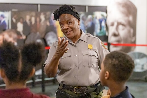 Superintendent of Martin Luther King, Jr. National Historical Park Judy Forte talks with students from the Tabernacle of Praise about a recently-installed exhibit that showed the connections between King and President Jimmy Carter Tuesday, Feb. 28, 2023.  (Steve Schaefer/steve.schaefer@ajc.com)