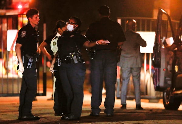 Officials investigate the scene where a woman was found stabbed to death in Piedmont Park on Wednesday morning. 