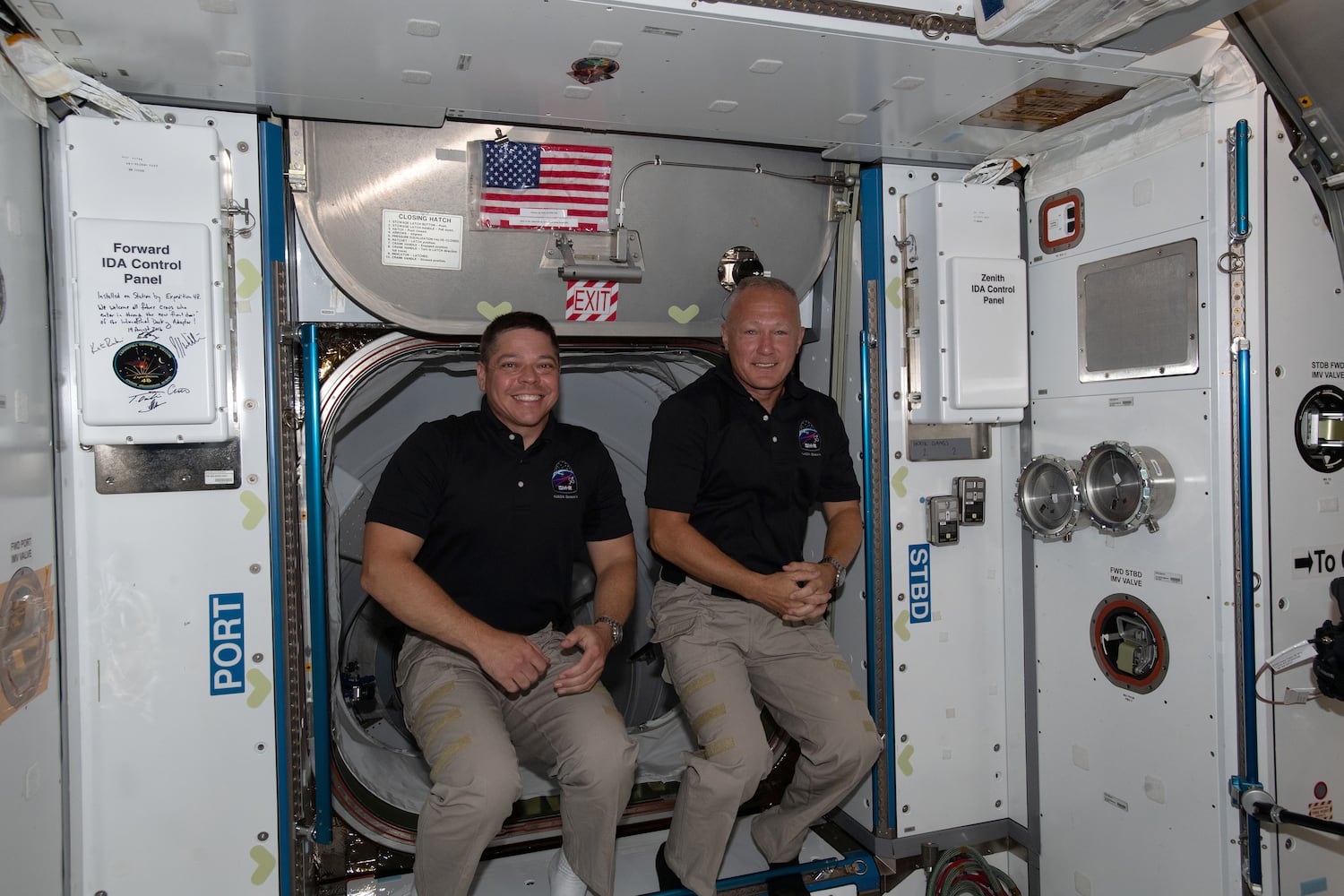 A photo provided by NASA shows the astronauts Bob Behnken, left, and Doug Hurley, having just entered the orbiting lab of the International Space Station shortly after arriving aboard the SpaceX Crew Dragon spacecraft, on May 31, 2020. Behnken and Hurley are getting ready to splash down after two months in orbit. (NASA via The New York Times) -- FOR EDITORIAL USE ONLY. --