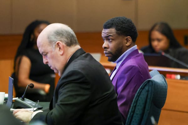 Defendant Deamonte Kendrick, right, sits next to his defense attorneys Doug Weinstein at the courtroom of Judge Ural Glanville at the Fulton County Courthouse, Friday, March 22, 2024, in Atlanta. (Jason Getz / jason.getz@ajc.com)