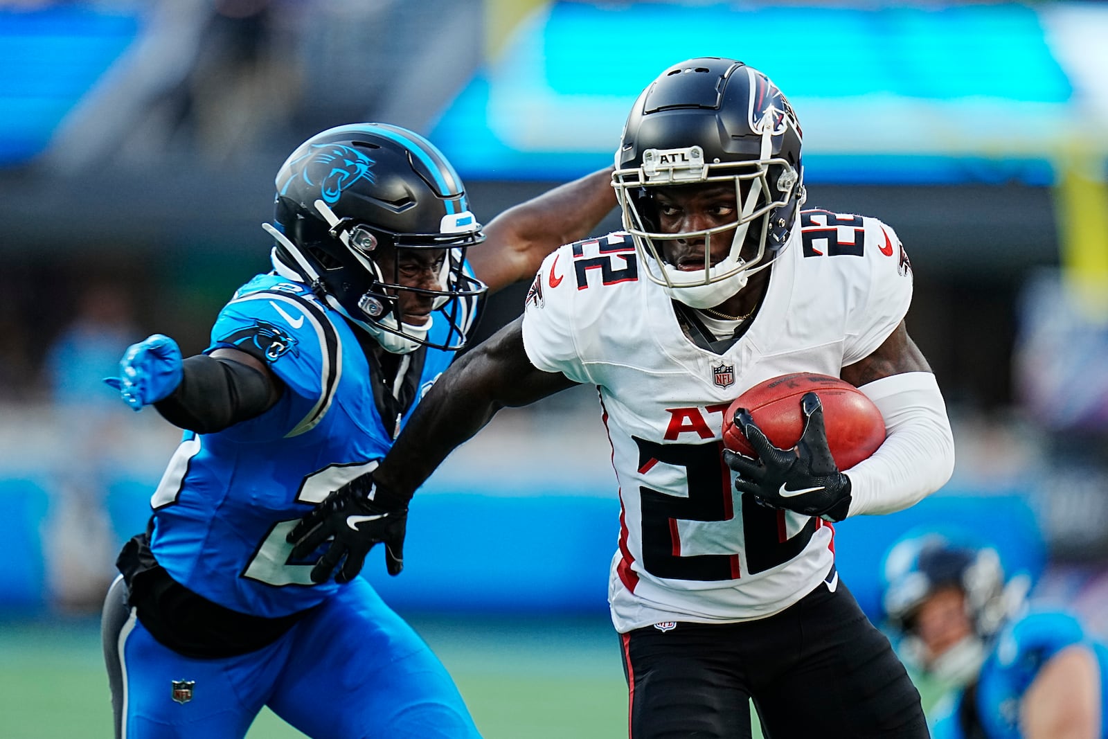 Atlanta Falcons cornerback Clark Phillips III (22) returns a punt against Carolina Panthers cornerback Chau Smith-Wade (26) in the first half of an NFL football game against the in Charlotte, N.C., Sunday, Oct. 13, 2024. (AP Photo/Rusty Jones)