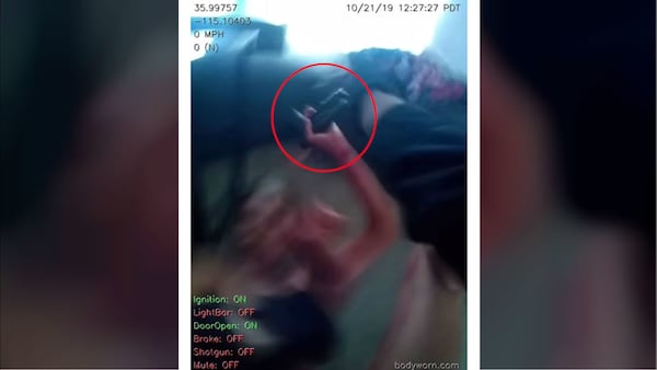 Claudia Nadia Rodriguez, 37, is seen on body camera footage clutching a police officer's gun moments before she was fatally shot Oct. 21, 2019. Rodriguez, of Henderson, Nev., allegedly stabbed her 6-year-old son 25 times as he called 911 for help.