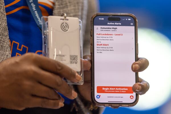 Staff members can trigger lockdowns with badges from Centegix, as demonstrated at Columbia High School in Decatur on Thursday, Aug. 3, 2023. School staff, school resource officers and district administrators all receive notifications to their phones in the event of a lockdown. (Arvin Temkar / arvin.temkar@ajc.com)