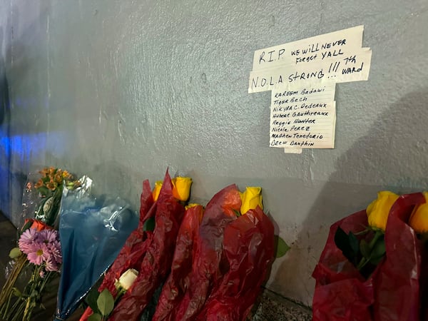 A makeshift memorial on the corner of Bourbon street, Thursday, Jan. 2, 2025, lists the names of some of the victims of the deadly attack, in New Orleans. (AP/Jack Brook)