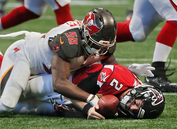 Falcons quarterback Matt Ryan (2) protects the ball after he fumbled as he was sacked by Buccaneers linebacker Shaquil Barrett (58) Nov. 24, 2019, at Mercedes-Benz Stadium in Atlanta. Tampa Bay won 35 -22.