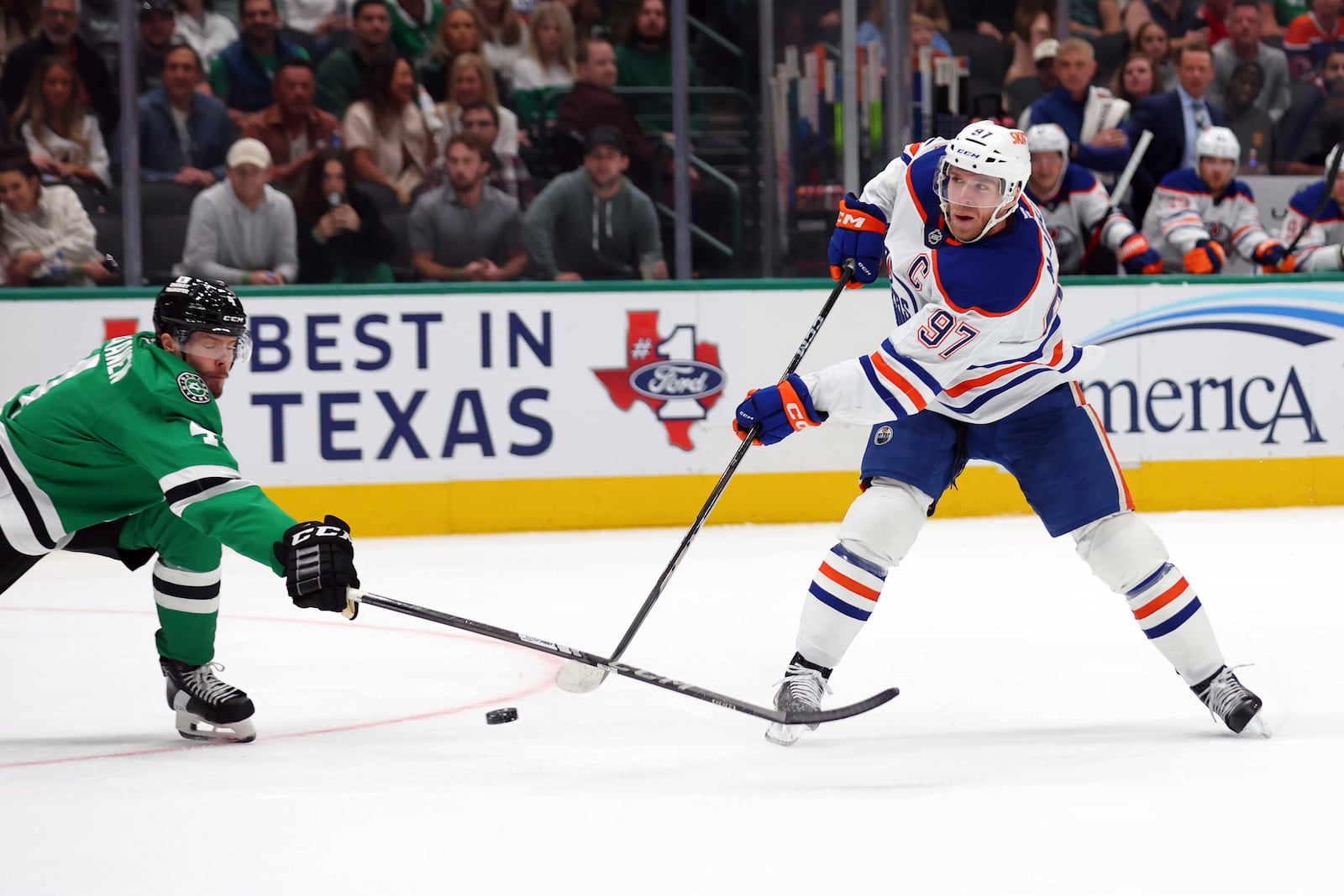 Dallas Stars defenseman Miro Heiskanen (4) tries to block a shot by Edmonton Oilers center Connor McDavid (97) in the second period during an NHL hockey game on Saturday, Oct. 19, 2024, in Dallas. (AP Photo/Richard W. Rodriguez)