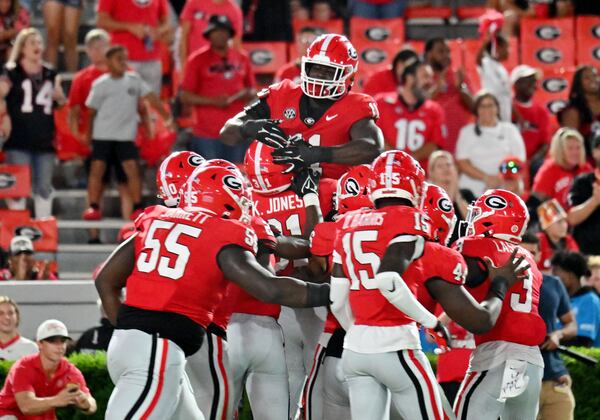 Georgia's running back Kyron Jones (31) celebrates with teammates after scoring a touchdown after intercepting a pass at the end of the fourth quarter in an NCAA football game at Sanford Stadium, Saturday, September 2, 2023, in Athens. Georgia won 48-7 over UT Martin. (Hyosub Shin / Hyosub.Shin@ajc.com)