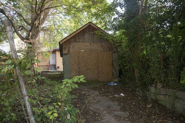 An abandoned shed that convicted prostitute Angela Dalton was known to frequent sits boarded up along Camilla Street SW in Atlanta’s Ashview Heights community. Until recently, many nearby houses were in the same state. “Camilla Street is just a lonely street, and I’m just wild as hell on it,” Dalton said. (ALYSSA POINTER / ALYSSA.POINTER@AJC.COM)