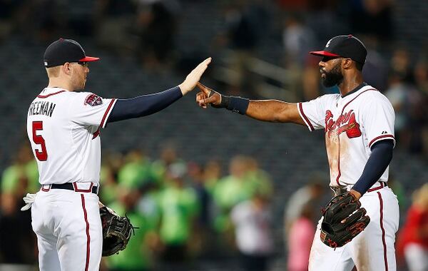 Atlanta Braves' Freddie Freeman, left, and Jason Heyward celebrate after defeating the Miami Marlins 6-1 in baseball game in Atlanta, Wednesday, July 23, 2014. (AP Photo) Is the Braves' run about to halt? (AP photo)