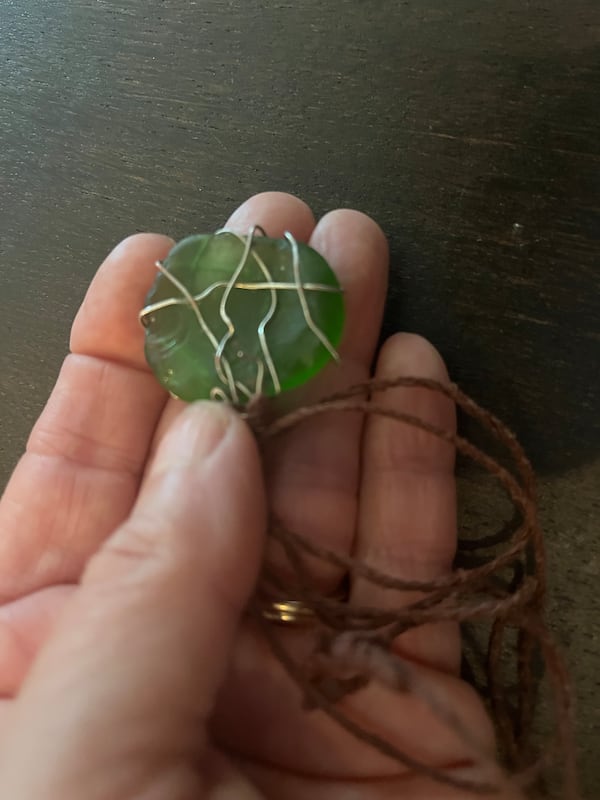 Allison Salerno golds the green river stone necklace that reminds her of the Appalachian Trail. (Courtesy of Allison Salerno)