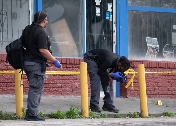 Atlanta police investigate a shooting scene at the Star Discount Food market after six people were shot Sunday afternoon.